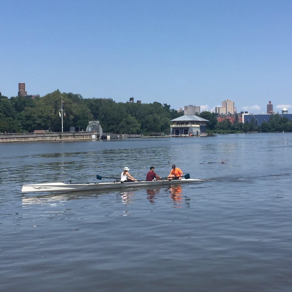 Rowers on the river, as seen from Roberto Clemente Park